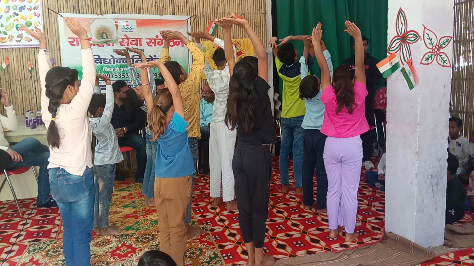 Children seated at the RHSS DLF Ultima centre with visitors and teachers